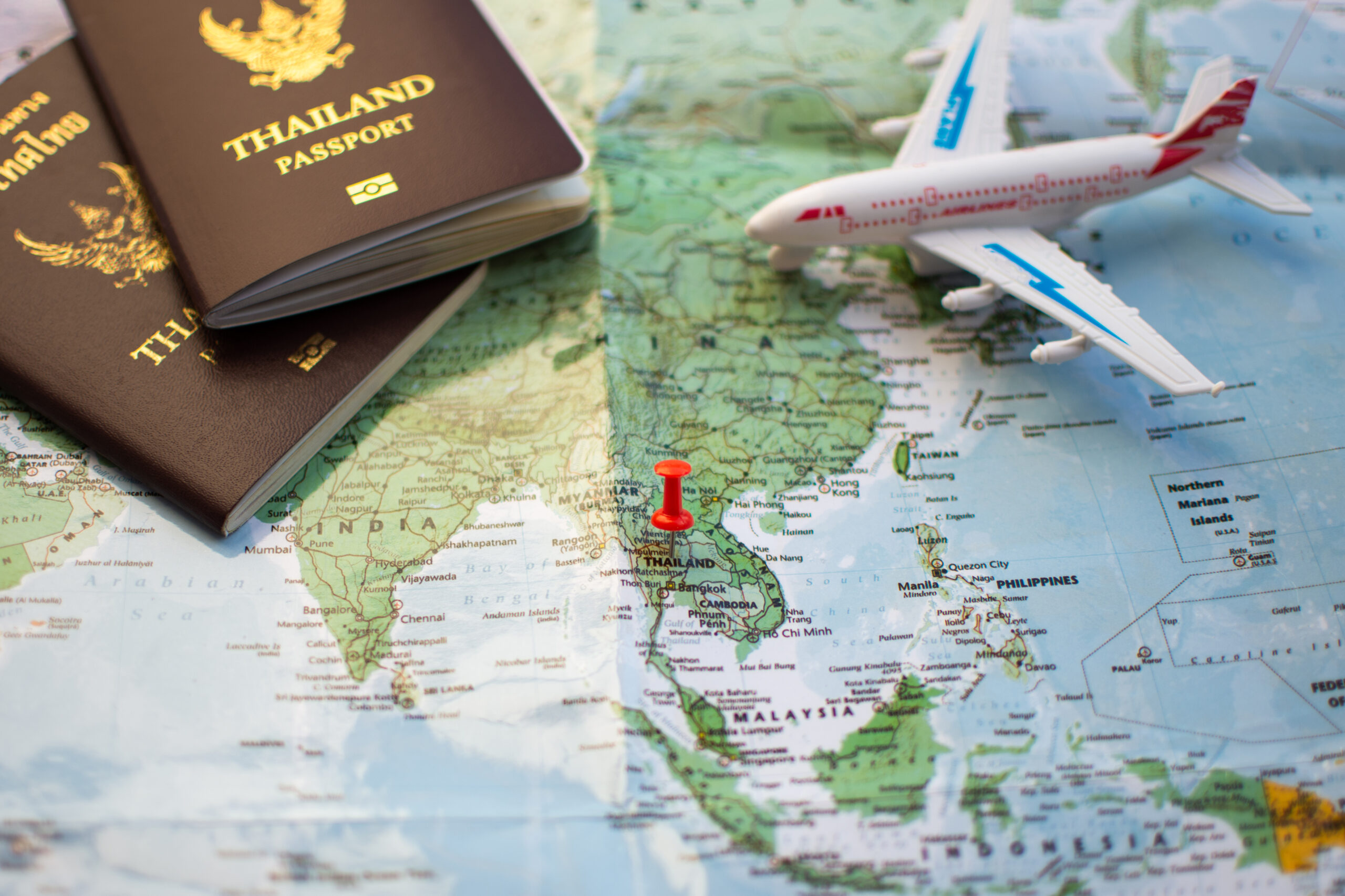 pin on location map for travel plan with passport compass camera